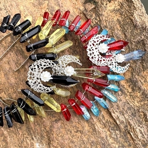 Handmade crown headband with natural colorful crystals and silver moon charms on rock background