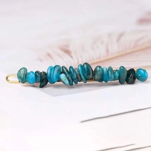 Detail of blue natural crystal stone hair clip with elegant golden metal base
