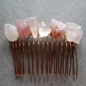 Detail of handmade hair comb featuring raw pink and clear natural crystal stones