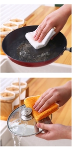 Close-up of a soft absorbent dishcloth being used to wipe a kitchen countertop