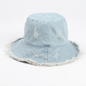 Detailed view of light blue denim bucket hat with frayed edges and distressed texture