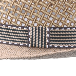 Close-up detail of a breathable straw jazz hat with a stylish striped ribbon band