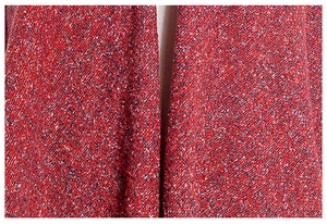 Close-up of thick red knit scarf showing detailed mixed red, black, and white boucle texture