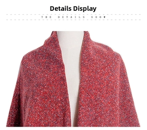 Detail shot of multicolor knit texture on red winter shawl over a white mannequin