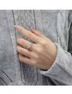 Close-up of double-layered open ring with sparkling pavé crystals on model hand