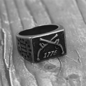 Vintage 316 stainless steel ring with 1776 muskets engraving on a wooden surface