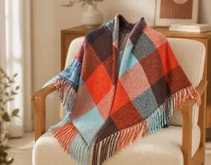 Detailed view of the plaid pattern and fringed edges on the oversized winter shawl