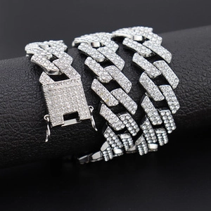 Close-up of silver Cuban chain necklace with sparkling crystals and iced-out buckle
