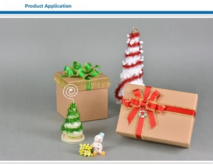 Gift boxes with Christmas ribbons, miniature trees, and festive holiday decorations