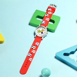 Detail of red silicone kids watch band with 3D soccer relief and Arabic numeral dial