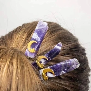 Handmade amethyst hair pins with gold moon and star accents on natural crystal shards