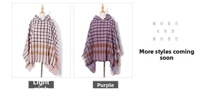 Detailed view of checkered hooded poncho featuring fringe hem and soft knitted fabric texture