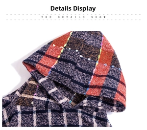 Detail view of the knit plaid hooded poncho featuring colorful textured bouclé yarn fabric