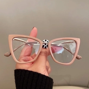Detailed shot of nude pink cat-eye glasses frame with 142 CE certification mark