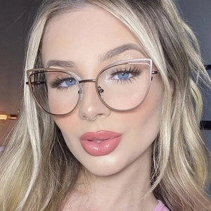 Close-up of cat-eye metal glasses frame in rose gold finish on fashion model