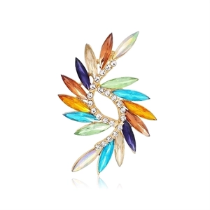 Macro shot of tulip-shaped brooch with colorful rhinestones and gold leaf setting