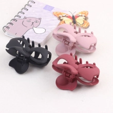 V-shaped plastic bow hair clips in black, pink, and burgundy for styling and curling