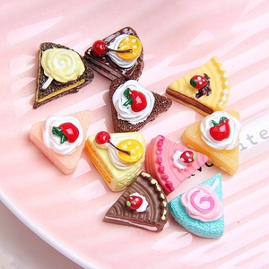 Assorted miniature resin triangle cake charms with fruit toppings for DIY crafts