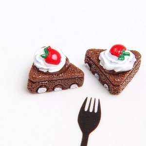 Macro view of miniature chocolate cake slice with strawberry and cream detail