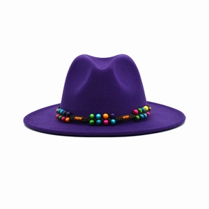 Detail of purple wool felt jazz hat featuring a colorful woven wooden bead band decoration