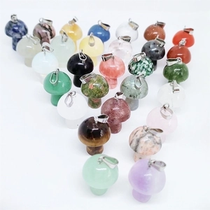 Close-up of assorted mini natural stone mushroom pendants with polished quartz textures
