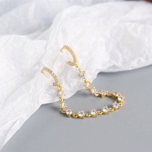 Detail of luxury S925 sterling silver hoop earrings with tassels and cubic zirconia