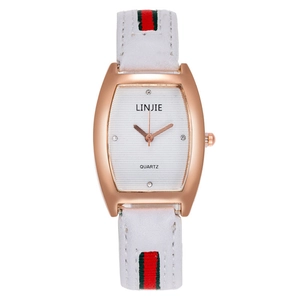 Macro detail of rose gold tonneau watch case with white textured dial and crystal indices