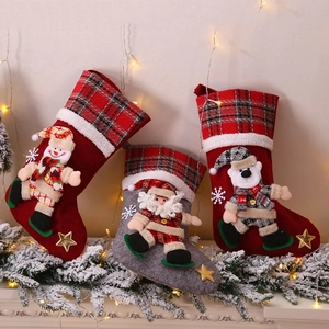 Large plaid Christmas stockings with Santa Snowman and Polar Bear dolls for holiday decor