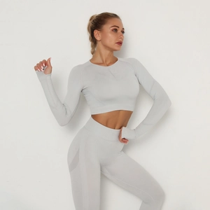 Detail of grey seamless yoga set showing high waist leggings and long sleeve crop top thumb holes