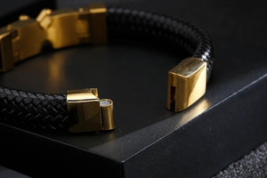 Macro view of magnetic clasp detail on black braided leather bracelet for men