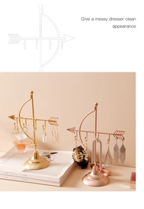 Macro detail of Cupid arrow jewelry display stand in gold and rose gold finish