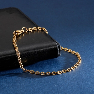 Golden titanium steel O-chain bracelet with lobster clasp on black leather display