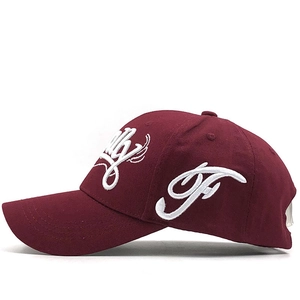 Classic burgundy cotton baseball cap with white 3D letter embroidery in a side view