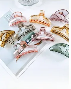 Detailed view of various colorful translucent heart-shaped hair claw clips for women