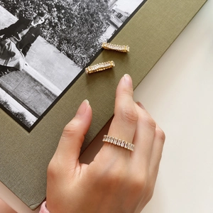 Close-up of gold-plated silver ring with rectangular-cut sparkling cubic zirconia