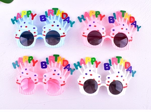Close-up of colorful cupcake-shaped birthday party sunglasses with Happy Birthday text