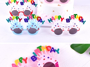 Detail of colorful cupcake-shaped Happy Birthday party sunglasses for kids' celebrations