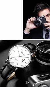 Detail of quartz men's watch with white dial, black leather strap, and date display