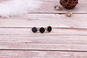 Detailed comparison of gold silver and rose gold plated rings on a rustic wooden background