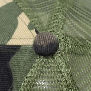 Macro detail of breathable green mesh and camouflage fabric on a summer baseball cap