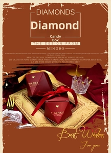 Detail of wine red diamond-shaped wedding favors with elegant gold ribbons and foil stamping