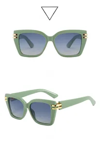 Detail of square green frames with gold metal accents and blue gradient sunglasses lenses