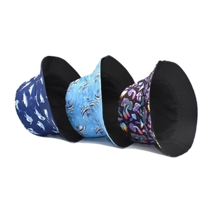 Reversible bucket hats featuring ocean shark, marlin, and mushroom print designs