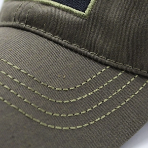 Close-up of military green canvas baseball cap showing durable stitching and fabric texture