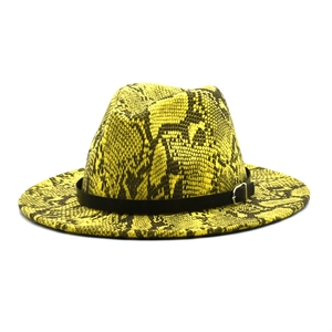 Detailed view of the yellow snake print pattern and black leather buckle on the jazz hat