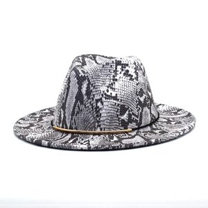 Close-up of black and white snakeskin fedora hat with elegant gold metal bar detail