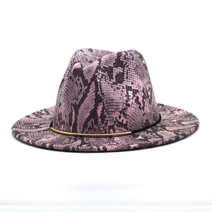 Detail of pink and black snakeskin fedora hat with black band and gold metal trim