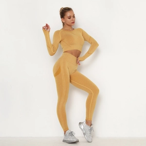 Close-up of ginger yellow seamless yoga set showing knitted texture and shaping lines