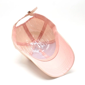 Detail view of pink baseball cap interior with adjustable strap and metal buckle closure