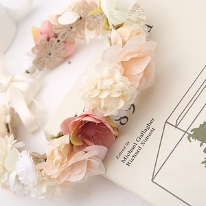 Romantic silk flower crown with pink and beige blossoms and lace ribbons for bridal hair